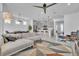 Bright open-concept living room with sectional sofa and dining and kitchen area, perfect for entertaining at 14317 Lanikai Beach Dr, Orlando, FL 32827