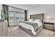 Beautiful main bedroom with large tufted headboard and three bright windows at 14317 Lanikai Beach Dr, Orlando, FL 32827