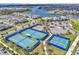 Aerial image featuring community tennis and basketball courts near a large lake at 14317 Lanikai Beach Dr, Orlando, FL 32827