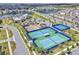 Aerial view showcasing tennis courts surrounded by lush landscaping and manicured grounds at 14317 Lanikai Beach Dr, Orlando, FL 32827