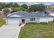 Inviting home features a two-car garage and a well-kept lawn, as well as charming stone accents at 1484 Patricia St, Kissimmee, FL 34744