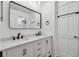 Bathroom with double vanity, framed mirror, and cabinet storage at 1484 Patricia St, Kissimmee, FL 34744