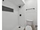 Updated bathroom with white subway tile shower, black fixtures, and decorative accent niche at 1484 Patricia St, Kissimmee, FL 34744