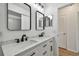 Bathroom with double sinks, framed mirrors, and modern fixtures at 1484 Patricia St, Kissimmee, FL 34744
