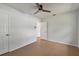 Spacious bedroom with tile floors, a ceiling fan, and two closets for storage at 1484 Patricia St, Kissimmee, FL 34744