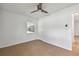 Cozy bedroom with tile flooring, ceiling fan, and a window offering natural light at 1484 Patricia St, Kissimmee, FL 34744