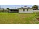 Back exterior view of house featuring a covered patio and sunroom overlooking the backyard at 1484 Patricia St, Kissimmee, FL 34744