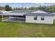 An elevated view of the rear of the home, showing the sunroom and covered patio at 1484 Patricia St, Kissimmee, FL 34744