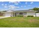 Charming single-story home with stone accents, a two-car garage, and a well-manicured lawn at 1484 Patricia St, Kissimmee, FL 34744