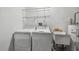 Functional laundry room with washer, dryer, utility sink, and shelving at 1484 Patricia St, Kissimmee, FL 34744