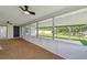 Bright sunroom with carpeted flooring and view of the yard with lake access at 1484 Patricia St, Kissimmee, FL 34744