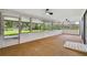 Screened sunroom with a view of the grassy yard and wooded area at 1484 Patricia St, Kissimmee, FL 34744