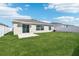 Large backyard with a green lawn, white fence, and a patio perfect for outdoor entertaining at 1533 Peach Creek Dr, Osteen, FL 32764
