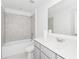 Bright bathroom features white cabinets, a shower-tub, and a sink with modern fixtures at 1533 Peach Creek Dr, Osteen, FL 32764