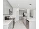 Modern kitchen with stainless steel appliances, quartz countertops, island, and ample cabinet space at 1533 Peach Creek Dr, Osteen, FL 32764
