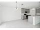 Open-concept living and kitchen area with pendant lighting and modern appliances at 1533 Peach Creek Dr, Osteen, FL 32764