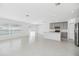 Bright, open-concept living and kitchen area with tile flooring and abundant natural light at 1533 Peach Creek Dr, Osteen, FL 32764