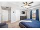 Well-lit bedroom showcasing a ceiling fan, stylish dresser, and a cozy seating area for added convenience at 1625 Smokey Oak Way, Longwood, FL 32750