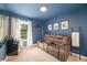 Cozy bonus room with a mini-fridge, a leather recliner, and a lake view, ideal for relaxation or entertainment at 1625 Smokey Oak Way, Longwood, FL 32750