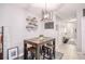 Cozy dining area featuring a rustic wood table, stools, and decorative open shelving, with view of hallway at 1625 Smokey Oak Way, Longwood, FL 32750