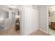 Hallway with a closet and access to an updated bathroom, showcasing the home's modern conveniences at 1625 Smokey Oak Way, Longwood, FL 32750