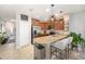 The kitchen features an island with bar seating, modern appliances, and tile flooring for easy maintenance at 1625 Smokey Oak Way, Longwood, FL 32750