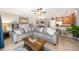 Living room boasts a comfortable gray sectional sofa, leading to the kitchen with a breakfast bar at 1625 Smokey Oak Way, Longwood, FL 32750