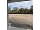 Backyard with a dirt patch and trees in the background at 1667 Meadowlark Dr, Deltona, FL 32725