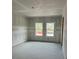 Spacious living room with drywall ready for finishing touches and ample natural light at 1667 Meadowlark Dr, Deltona, FL 32725