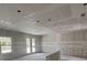 Bright, unfinished living room with double doors and windows for ample natural light at 1667 Meadowlark Dr, Deltona, FL 32725