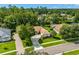 Aerial view of a beautiful home with a well-manicured lawn, mature landscaping and a circular driveway at 1679 Shadowmoss Cir, Lake Mary, FL 32746
