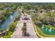 An aerial view of a gated entrance to a planned community with water features and luxury homes at 1679 Shadowmoss Cir, Lake Mary, FL 32746