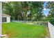Spacious fenced backyard featuring lush lawn and mature trees, creating a private outdoor oasis at 1679 Shadowmoss Cir, Lake Mary, FL 32746