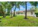 Spacious backyard with mature trees and a white fence, offering privacy and tranquility at 1679 Shadowmoss Cir, Lake Mary, FL 32746