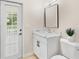 Stylish bathroom featuring an updated marble vanity, a modern mirror, and a bright outdoor view at 1679 Shadowmoss Cir, Lake Mary, FL 32746