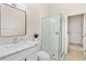 Bright bathroom featuring a modern glass shower, a marble vanity, and an updated mirror at 1679 Shadowmoss Cir, Lake Mary, FL 32746