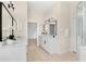 Modern bathroom features double vanities, sleek fixtures, and a glass-enclosed shower at 1679 Shadowmoss Cir, Lake Mary, FL 32746