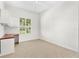 Carpeted bedroom features a built-in desk and a window with plantation shutters at 1679 Shadowmoss Cir, Lake Mary, FL 32746