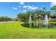 Community entrance featuring lush landscaping, fountains, and a picturesque pond for a welcoming feel at 1679 Shadowmoss Cir, Lake Mary, FL 32746