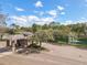 A gated entrance to a community with a fountain and pond in the background at 1679 Shadowmoss Cir, Lake Mary, FL 32746