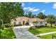 Charming single-story home featuring a tile roof, manicured landscaping, and a circular driveway at 1679 Shadowmoss Cir, Lake Mary, FL 32746