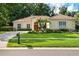 Charming single-story home featuring a well-manicured lawn and mature landscaping at 1679 Shadowmoss Cir, Lake Mary, FL 32746