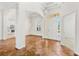 Open foyer with high ceilings, chandelier, tiled floor, and views into the kitchen at 1679 Shadowmoss Cir, Lake Mary, FL 32746