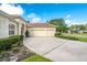 Attached two car garage with long driveway, surrounded by manicured landscaping at 1679 Shadowmoss Cir, Lake Mary, FL 32746