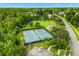 Overhead shot of community tennis courts surrounded by mature trees and green space at 1679 Shadowmoss Cir, Lake Mary, FL 32746