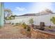 Well-manicured backyard with a patio area, flower beds, and a white fence at 17 Hibiscus Ct, Eustis, FL 32726