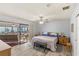 Bedroom with slider to covered porch with bench swing and traditional furnishings at 17 Hibiscus Ct, Eustis, FL 32726