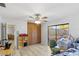 Bright bedroom with wood floors, built-in storage, and sliding doors to a private outdoor patio at 17 Hibiscus Ct, Eustis, FL 32726