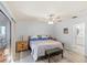 Well-lit bedroom with wood-look floors and furnishings and a door to the ensuite at 17 Hibiscus Ct, Eustis, FL 32726