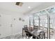 Sunroom with dining set, cathedral windows, glass roof, and access to outdoor space at 17 Hibiscus Ct, Eustis, FL 32726